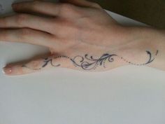 a person's hand with a small tattoo on the middle of their left wrist