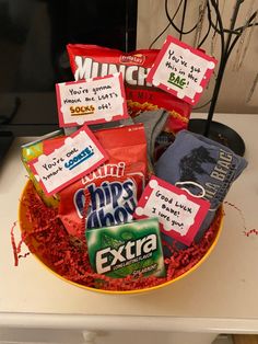 a bowl filled with candy and snacks on top of a table