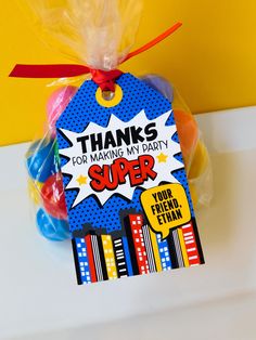 a bag with some candy in it and a tag that says thanks for making my party super