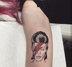 a woman's arm with a tattoo of a man wearing a bandana on it