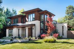 a large house with lots of windows in the front yard