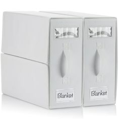 two white boxes with labels on them sitting next to each other in front of a white background