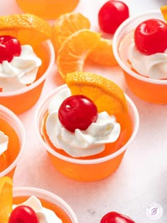 orange cups with whipped cream and cherries on top