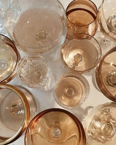 there are many empty wine glasses on the table