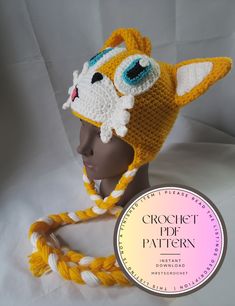 a crochet hat with a cat on it and a rope around the brim