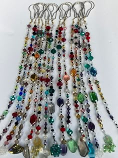 a bunch of different colored beads hanging from hooks