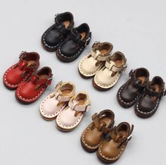 several pairs of baby shoes sitting on top of each other