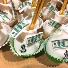 some cupcakes with money on them and sticks sticking out of them