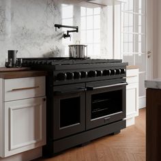 a black stove top oven sitting inside of a kitchen next to a white countertop