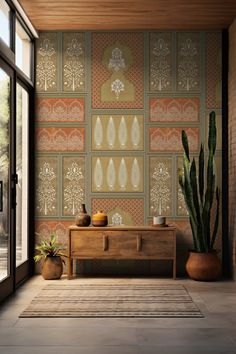 a living room with a couch, table and cactus in front of the wallpaper