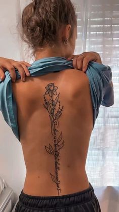 a woman with a tattoo on her back