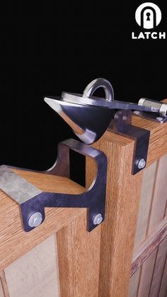 a close up of a wooden door with metal latches on the front and side