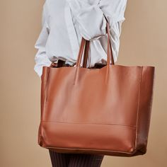 A highly functional holdall, this leather tote will carry all your essentials throughout the day. Boasting a soft, leather in a gorgeous deep color tone, complete with sturdy leather handles and an inner zip pocket for added security. Handmade in Italy 100% from NATURAL genuine leather The bag comes with a small pouch on the inner part of the bag (zipper), and without any linings fabrics (natural leather lining). Professional craftsmanship and excellent quality, soft touch but strong genuine leather! Width: 17.7 inch / 45cm Height: 13.9 inch / 35,5cm Depth: 3.9 inch / 10cm Standard handles height: 8.6 inch/22 cm Weight: 10oz / 300grams FEATURES -Inside zip pocket -Inside leather slots -Padded leather handles -Suede raw interior lining -Easy hand and shoulder carrying -Italian materials & w Leather Tote Weekender Bag For On-the-go, Rectangular Textured Leather Bag For On-the-go, Large Capacity Leather Bag For Daily Use, Soft Leather Tote Travel Bag For On-the-go, Smooth Grain Tote Hobo Bag For Work, Smooth Grain Hobo Bag Tote For Work, Soft Leather Bags With Double Handle For Work, Smooth Grain Hobo Bag In Tote Shape For Work, Smooth Grain Tote Shoulder Bag For Work