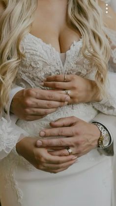 a close up of a person wearing a wedding dress and holding her hands on her chest