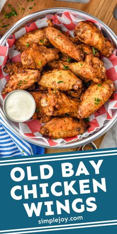 old bay chicken wings in a bowl with ranch dressing on the side and text overlay