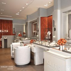 the interior of a jewelry store with white furniture and flowers in vases on tables