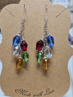 "These earrings are handmade using Swarovski crystals in shades of red, green, blue, gold and clear ab (aurora borealis).  The silver chain, spacers and ear wires are all .925 sterling silver (not plated or mystery metal)  They are approximately 2 1/4 inches long.   Little clear rubber \"stoppers\" that can be placed on the back of the earring to prevent loss will be included.  The earrings will come packaged in a pretty little organza pouch, perfect for gift giving or storage." Holiday Beaded Jewelry, Diy Christmas Earrings, Xmas Jewelry, Diy Earrings Easy, Earring Kit, Beaded Earrings Tutorials, Organza Pouch, Jewelry Making Earrings