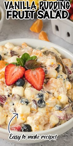 a white bowl filled with fruit salad and topped with a strawberry