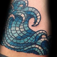 a blue and white tattoo design on the arm