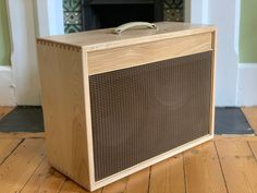 a wooden box sitting on top of a hard wood floor