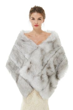 a woman in a white dress wearing a fur shawl and posing for the camera