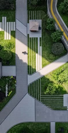 an aerial view of a road and parking lot in the middle of a grassy area