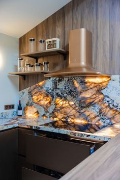 a kitchen with marble counter tops and wooden shelves on either side of the stove top