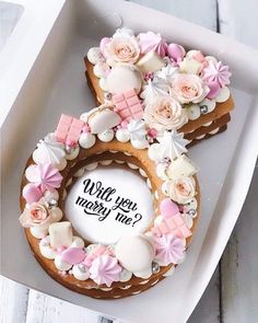 two decorated cookies in the shape of an oatmeal with pink and white flowers