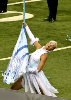 a woman in white dress holding up a flag