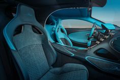 the interior of a sports car with blue leather