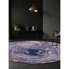 a round rug with an image of the stars in the sky on top of it