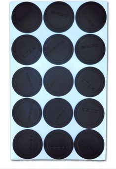 black plastic coasters with the words and numbers on them, all in different sizes