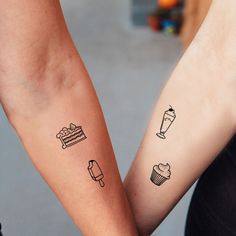 two people holding hands with tattoos on their arms, one has a cake and the other has a cupcake