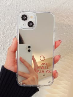 a woman holding up her phone case that says i just really miss you