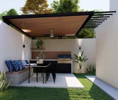 an outdoor kitchen and dining area is shown in this backyard setting with green grass, white walls, and black furniture