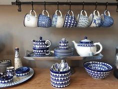 blue and white pottery is displayed on a shelf