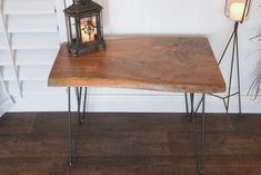 a wooden table with two candles on it