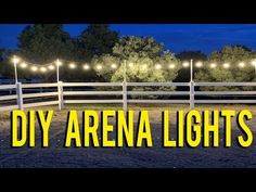 the words diy arena lights are lit up in front of a white fence and trees