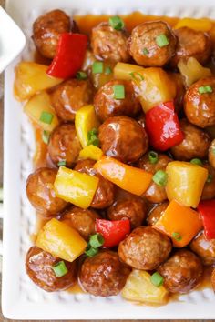 a white plate topped with meatballs and veggies