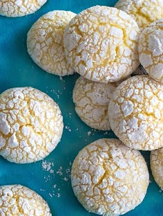 several powdered sugar cookies on a blue plate