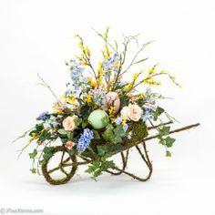 a wheelbarrow filled with flowers and greenery