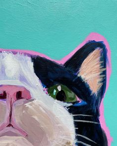 a painting of a black and white cat's face with green eyes on a blue background