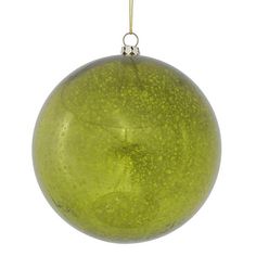 a green ornament hanging on a white background