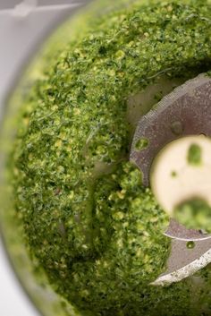 a food processor filled with green pesto