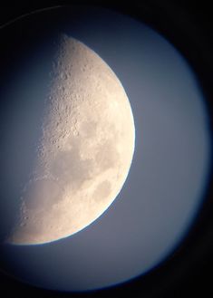 the moon is seen through an airplane window