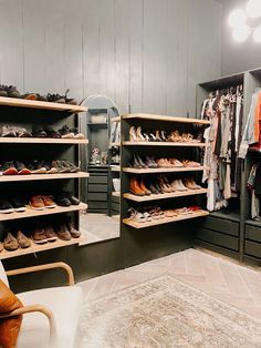 a large closet with several shelves filled with shoes