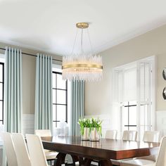 a dining room table with white chairs and a chandelier