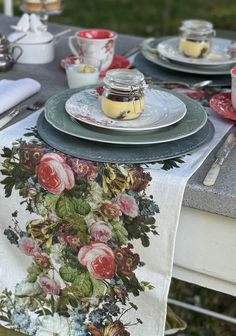 a table set with plates, cups and saucers