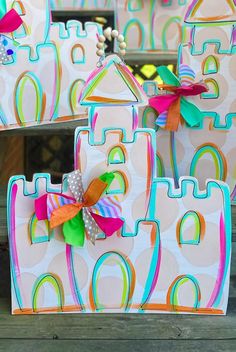 colorful castle shaped boxes with bows on them