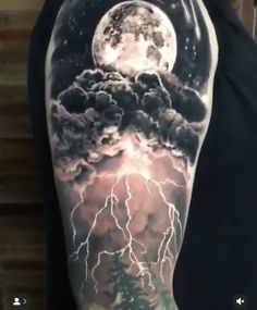 a man's arm with lightning and clouds on it